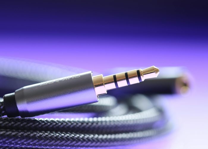 Detailed macro image of a 3.5mm audio jack cable with a braided wire.
